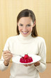 Photo: Woman eating strawberry jelly. Woman eating strawberry jelly.