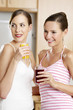 Photo: Women holding glasses of orange and blackcurrant juice. Women holding glasses of orange and blackcurrant juice.