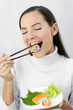Woman having japanese cuisine.