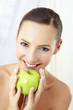 Woman holding a green apple.