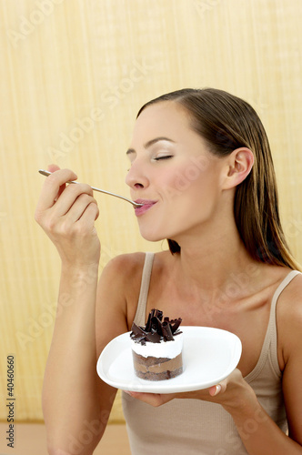 Photo: Woman eating cake. Woman eating cake.