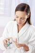 Woman pumping out some facial cleanser.