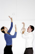 Man and woman playing with crumpled paper.