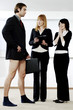 Businesswomen laughing at their colleague for not wearing pants to work.