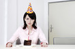 Businesswoman celebrating birthday alone.