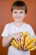 Portrait smiling boy with bananas