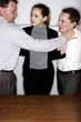 Businesswoman trying to cool off two angry men.