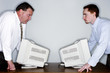 Photo: Two businessmen looking at each other angrily. Two businessmen looking at each other angrily.