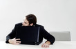 Businessman sleeping on briefcase.