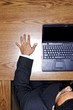 Foto: Top angle view of businessman using the laptop. Top angle view of businessman using the laptop.
