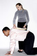 Woman placing documents on her colleague's back.