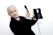 Photo: Phone cord entangling around businessman's neck. Phone cord entangling around businessman's neck.