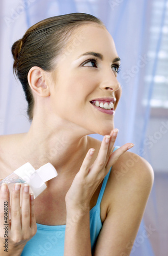 Photo: Woman applying some facial gel on her face. Woman applying some facial gel on her face.