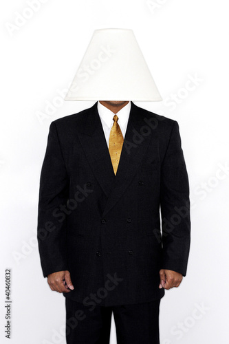 Foto: Businessman with a lamp covering his head. Businessman with a lamp covering his head.