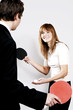 Businessman and businesswoman playing table tennis.
