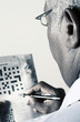 Businessman doing crossword puzzle.