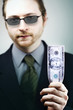 Businessman holding US dollar.