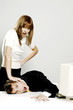 Businesswoman pressing her colleague's face against the table.