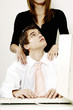 Businesswoman giving her colleague a shoulder massage.