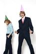 Photo: Businessman and businesswoman wearing party hats. Businessman and businesswoman wearing party hats.