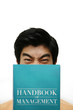 Man holding handbook of management.