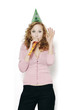Photo: Businesswoman with party hat blowing a blowout. Businesswoman with party hat blowing a blowout.