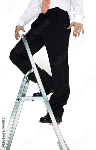 Photo: Businessman standing on top of a ladder. Businessman standing on top of a ladder.