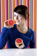 Woman holding blood oranges.