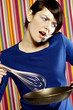 Woman talking on the handphone while cooking.