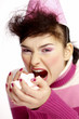 Woman trying to eat a handful of marshmallows.