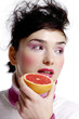 Woman holding a blood orange.