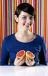 Photo: Woman holding blood oranges. Woman holding blood oranges.