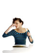Woman closing her nose while cutting fish.