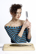 Woman testing the sharpness of a knife.