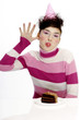 Woman with party hat sticking out her tongue.