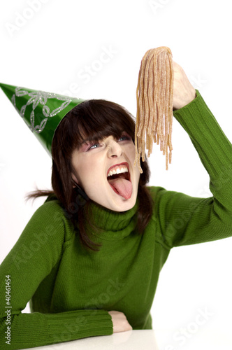 Photo: Woman eating candy. Woman eating candy.