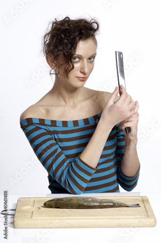 Photo: Woman testing the sharpness of a knife. Woman testing the sharpness of a knife.