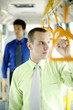 Photo: Corporate people standing in the train. Corporate people standing in the train.