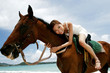Photo: Woman horse riding on the beach. Woman horse riding on the beach.