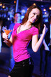 Young woman having fun at nightclub disco