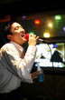 Man singing in a karaoke lounge.