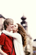 Woman giving her boyfriend a peck on the cheek.