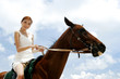Photo: Woman riding a horse. Woman riding a horse.