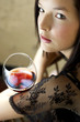Woman holding a glass of red wine.