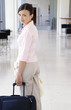 Woman pulling her travelling bag.