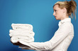 Woman holding a stack of towels.