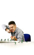 Businessman playing with his toy soldiers.