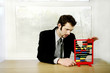 Businessman playing with children abacus.