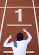 Businessman crawling on the running track.