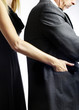 Female pickpocket stealing from a businessman.